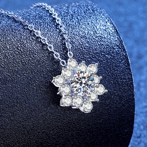 S925 sterling silver snowflake necklace with moissanite pendant on a blue background