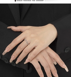 Close-up of S925 sterling silver beaded knot ring on hand with professional suit background