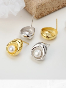 Close-up of S925 sterling silver stamp on organic oval earrings with freshwater pearls