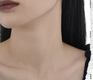 Close-up of minimalist vintage S925 sterling silver geometric stud earring on model