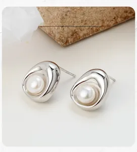 Macro shot of S925 sterling silver geometric oval stud earring with a freshwater pearl