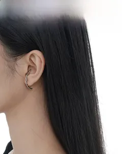 Close-up of S925 sterling silver ear cuff with vintage twisted rope texture on model