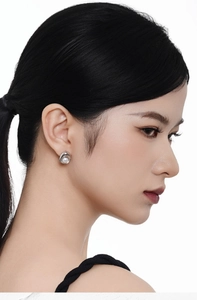 Close-up of elegant S925 sterling silver geometric earring with a white freshwater pearl