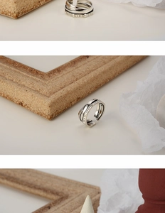 Macro detail of S925 sterling silver vintage triple-layered twisted textured ring