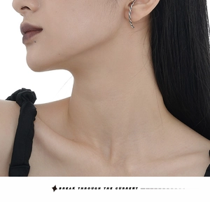 Close-up of a vintage S925 sterling silver twisted ear cuff on model's ear