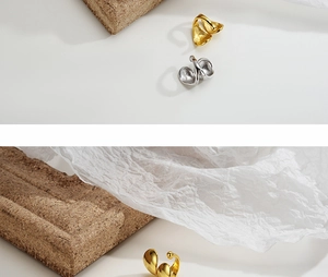 Detail of minimalist S925 silver double-layer ear cuff in gold and silver organic design