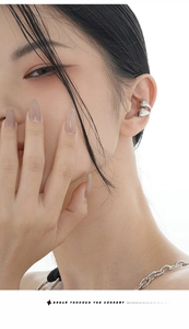 Detail of minimalist S925 sterling silver double-layered ear cuff worn by a model