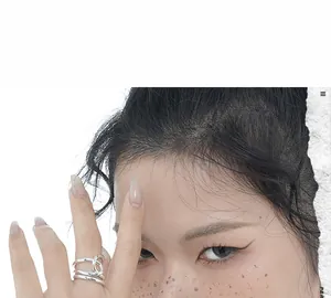 Close-up of minimalist S925 sterling silver ring with multilayered interlaced design
