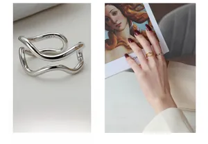 Detailed macro view of S925 sterling silver wavy ring with engraved hallmark on inner band