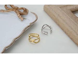 Close-up of irregular wave double-layer S925 silver rings in gold and silver finish