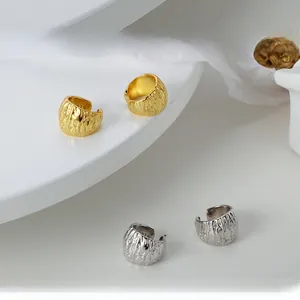Dettaglio di ear cuff in argento S925 con texture lava nelle finiture oro e argento