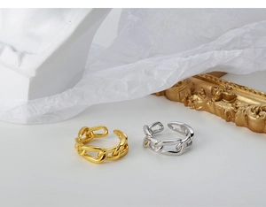 Close-up of gold and silver S925 sterling silver chain rings with polished mirror finish