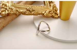 Dettaglio ravvicinato dell'anello in argento sterling S925 con linee ondulate minimaliste