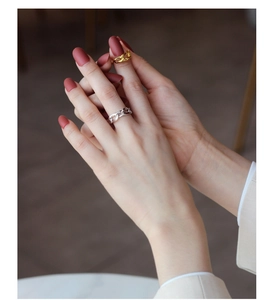 Close-up of minimalist S925 sterling silver chain link rings in gold and silver finish