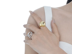 Close-up of minimalist irregular gold lava ring and interlocking silver dual band rings