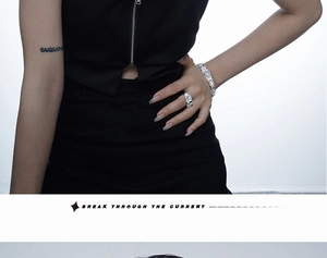 Detail shot of 925 sterling silver wrinkled texture ring and pavé bracelet on model