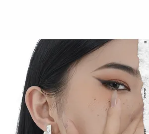 Close-up of asymmetrical silver cheese earring with pearl on female model ear