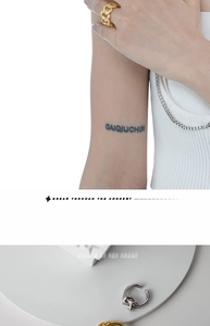 Detail of layered S925 silver rings with intertwined knot and chain design in gold and silver