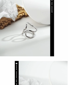 Macro shot of polished silver wavy textured ring with minimalist geometric design lines