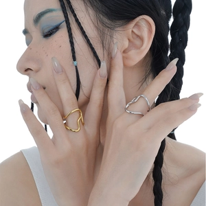 Artistic wave design open rings in gold and silver finish on a model's hand
