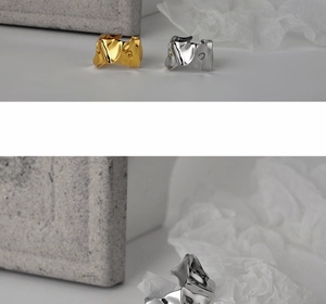 Detailed macro of gold and silver irregular textured rings with melted metal effect