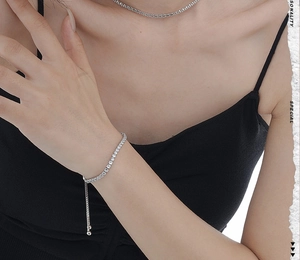 Close-up of S925 silver tennis necklace and adjustable tennis bracelet with cubic zirconia
