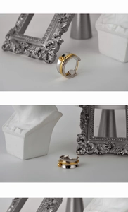 Detailed view of S925 silver two-tone layered ring with elegant gold bead accent