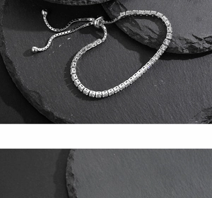 Detail of S925 silver tennis bracelet featuring square-cut zircons and adjustable slider