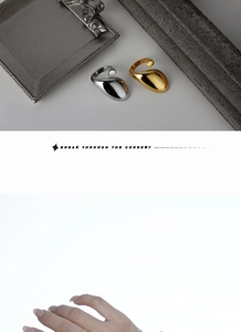 Detailed view of polished S925 sterling silver drop rings in gold and silver finishes