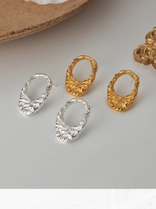 Detailed view of oval textured S925 silver stud earrings in gold and silver finishes