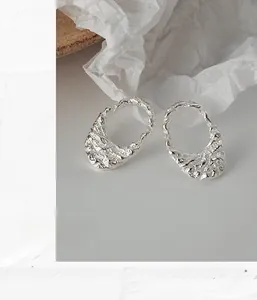Detailed view of S925 sterling silver earrings with irregular lava texture and silver finish