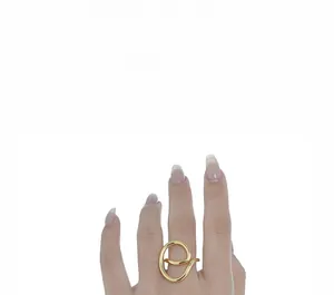 Close-up of golden abstract geometric ring featuring minimalist S925 sterling silver lines