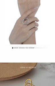 Detail of minimalist S925 sterling silver spiral ring in gold and silver finishes