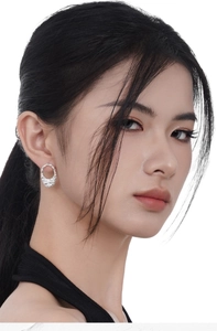 Detailed close-up of S925 silver stud earrings with a textured foil finish on model