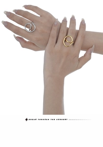 Close-up of minimalist S925 sterling silver hollow E-letter rings in gold and silver finish