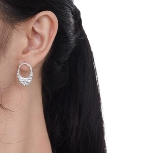 Minimalist S925 sterling silver stud earrings with irregular tin foil texture on model