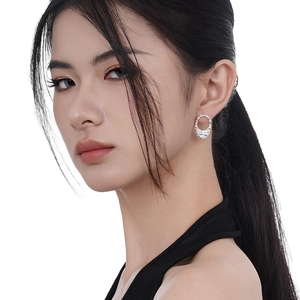 Minimalist S925 sterling silver stud earrings with lava texture on a female model