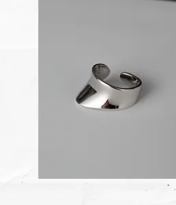 Detailed macro view of S925 sterling silver stamp on minimalist concave wide band ring