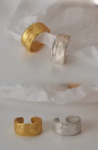 Detail of S925 sterling silver ear cuffs with unique lava texture in gold and silver finish