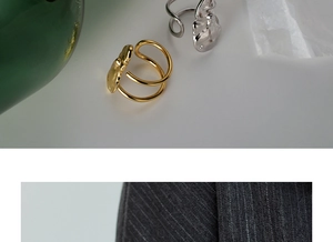 Detail of minimalist S925 sterling silver irregular lava texture rings in gold and silver