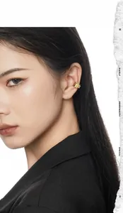 Detail of geometric gold ear cuff with square zircon on minimalist hollow double band