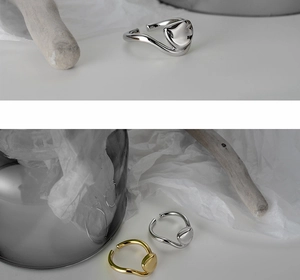 Detailed view of liquid metal style irregular rings in gold and silver finish