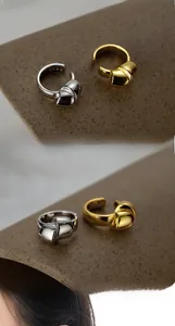 Detailed macro view showing the S925 hallmark on minimalist silver knot ear cuffs