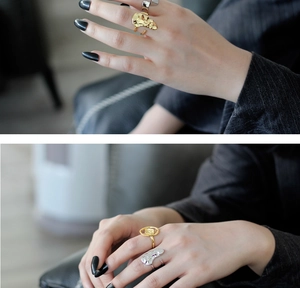 Detailed view of chunky S925 sterling silver rings with irregular lava texture in gold and silver