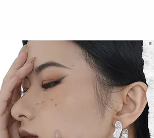 Close-up of S925 sterling silver stud earrings with hammered crinkle texture on model