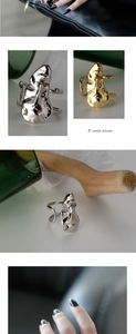 Macro detail of artistic S925 sterling silver rings with abstract face designs