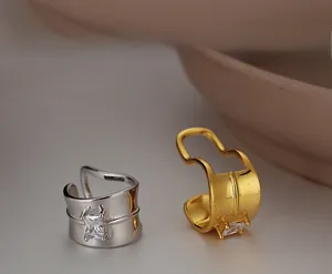 Close-up of gold and silver S925 sterling silver ear cuffs with square zirconia details