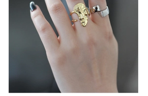 Detailed close-up of S925 silver abstract face ring and irregular textured band on a hand