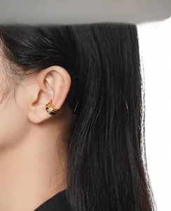 Detail view of minimalist gold ear cuff with square zircon and hollow double lines