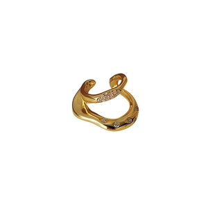 Minimalist double layer irregular gold ear cuff with sparkling zircon accents on white background